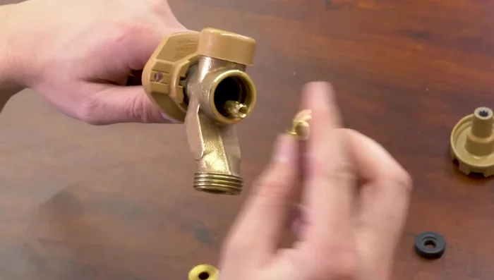 Reinstall the handle and tighten the screw.