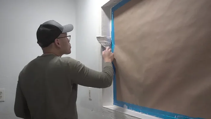 Apply and smooth the first coat of joint compound. Let it dry, sand it, and then apply a second coat.