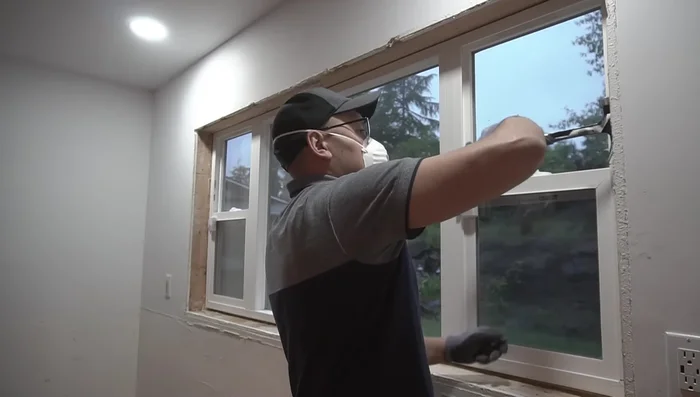 Clean and prepare the area around the window. Remove old trim, nails, and damaged drywall. Address any rot or mold.