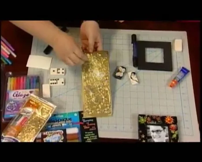 Peel a vinyl sticker and place it onto the domino. Fold over any overhanging edges.