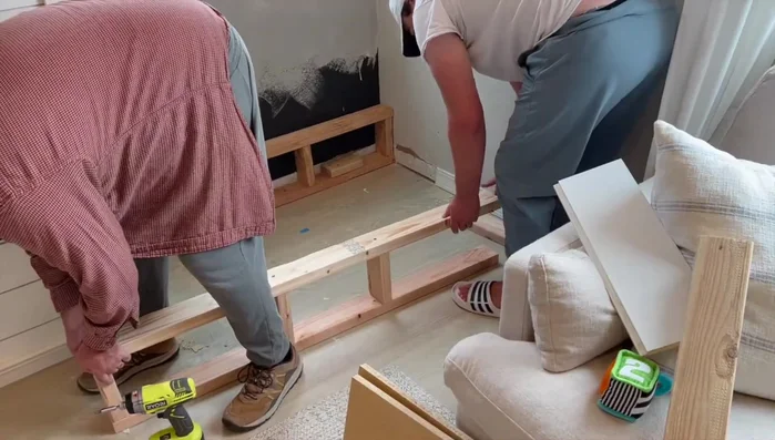 Build a higher base for the bench using the same method as the shelves, but with two upright 2x4 structures.