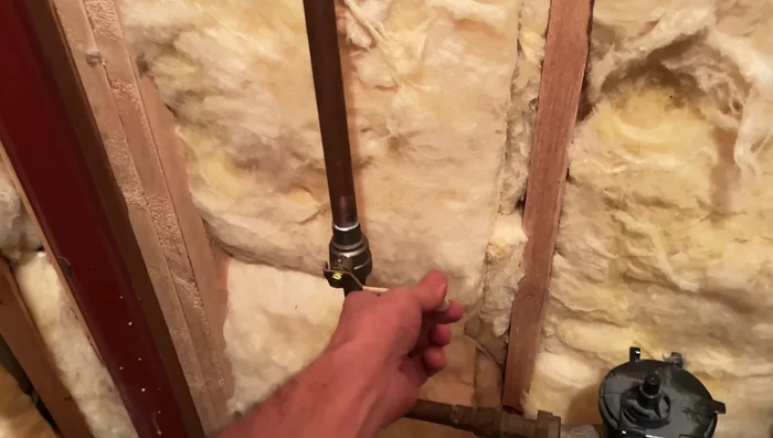 Turn off the main water valve and drain water from the lowest point in your home to minimize mess.