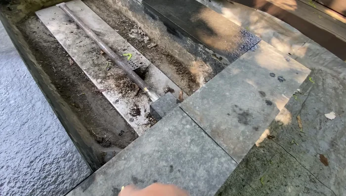 Layout the cut tiles on the fire pit surface to plan the arrangement.