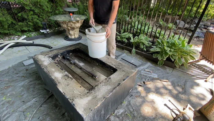 Apply the basalt tiles, pressing gently to ensure good contact with the thinset. Let it cure overnight.