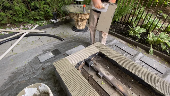 Apply the basalt tiles, pressing gently to ensure good contact with the thinset. Let it cure overnight.