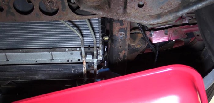 Drain the radiator coolant using the petcock on the passenger side.