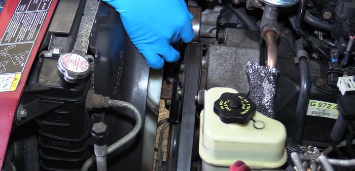 Remove the water pump pulley bolts.