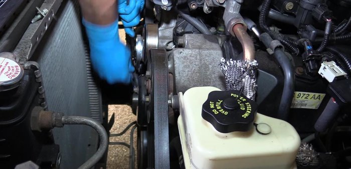 Remove the water pump pulley bolts.