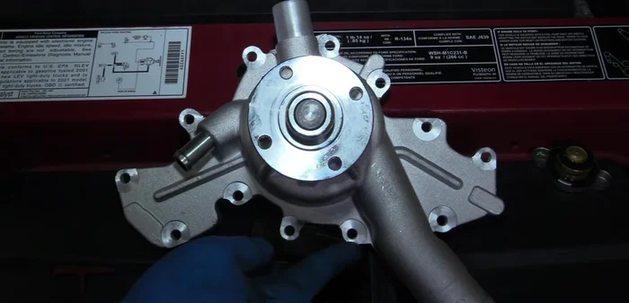 Remove the water pump by removing twelve 8mm bolts.