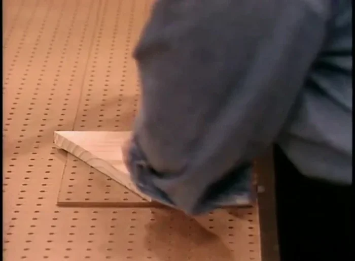 Apply wood glue to the back of wood molding strips and attach them to the edges of the pegboard to add thickness and cover raw edges.