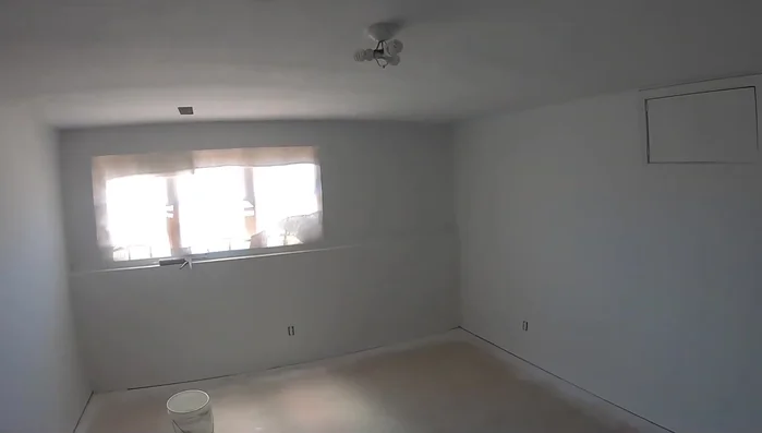 Prime the walls. A sprayer is faster, but a roller works fine.