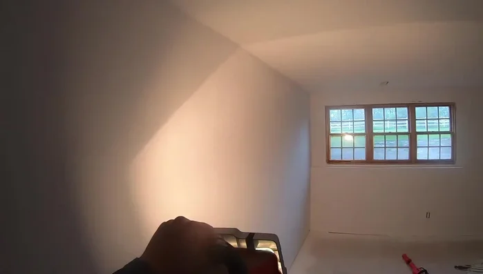 Use a bright light to check for remaining imperfections and fill them with spackle.