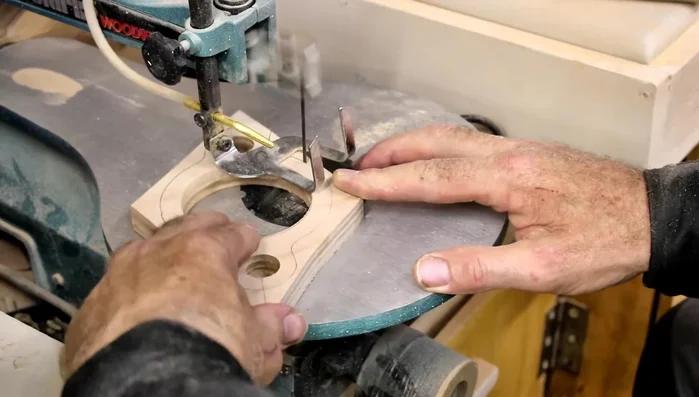 Shape the plywood pieces using a scroll saw (or file) and sand them down.