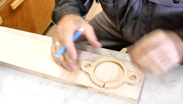 Shape the plywood pieces using a scroll saw (or file) and sand them down.