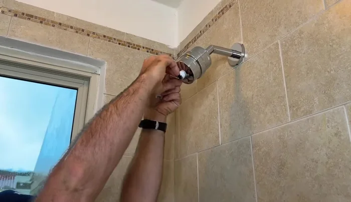 Use an adjustable wrench to give the shower head a final turn.