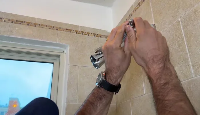 Use an adjustable wrench to give the shower head a final turn.