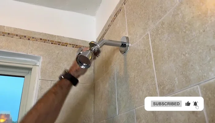 Remove the old shower head using an adjustable wrench (and optionally a cloth for extra care).