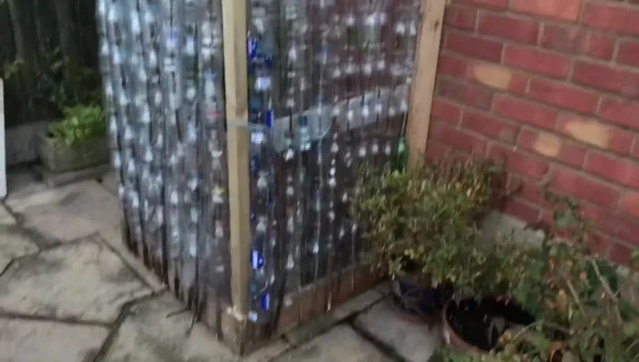 Secure the structure: Use screws and nails to firmly attach the plastic bottle walls to the wooden frame.