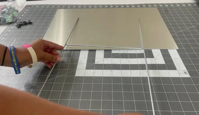 Attach to stake: Position the metal panel onto the metal stake. Secure it using adhesive cable clips and crazy glue for extra strength.