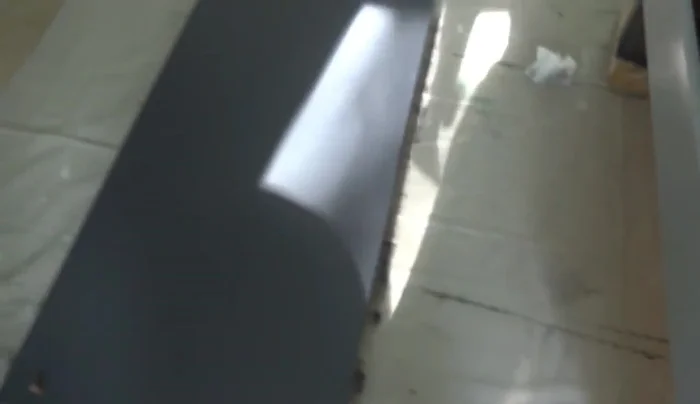 Assemble the coffee table by attaching the legs and handles.