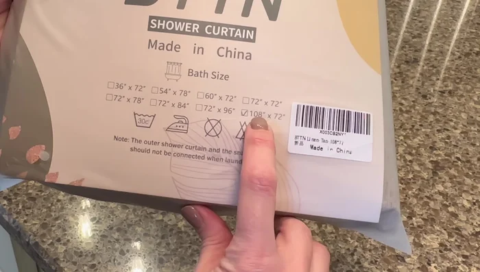 Install the new shower curtain and rings.