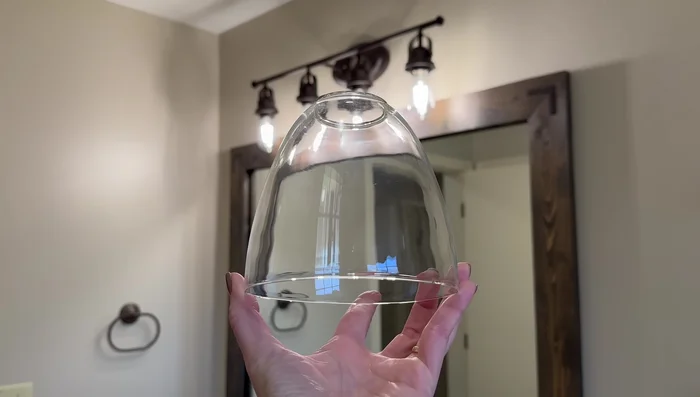 Add the glass globes to the light fixture for a changed look. Replace the bulbs with shorter ones to avoid a cluttered look.