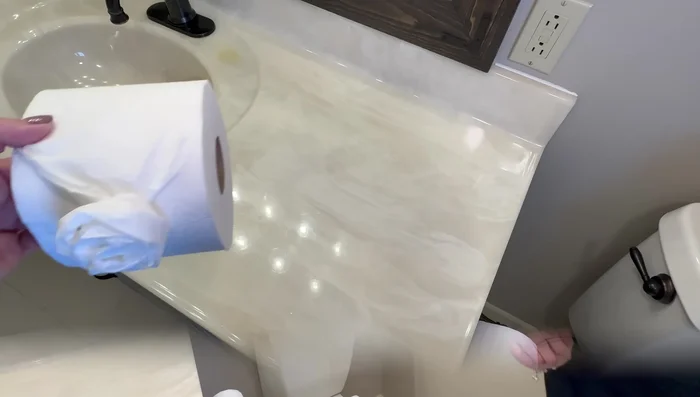 Dress up toilet paper using a simple flower-folding technique to add a luxurious touch.