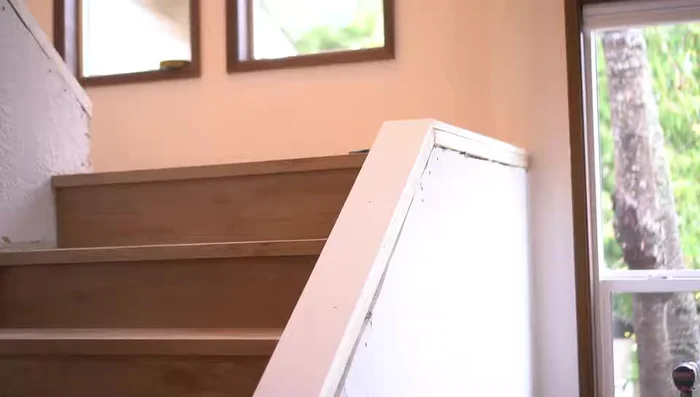 Install side trim, ensuring accurate mitered angles and flush connection with the top cap.