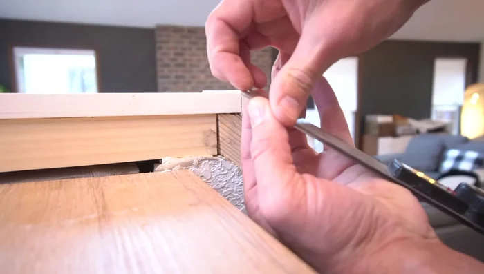 Install side trim, ensuring accurate mitered angles and flush connection with the top cap.