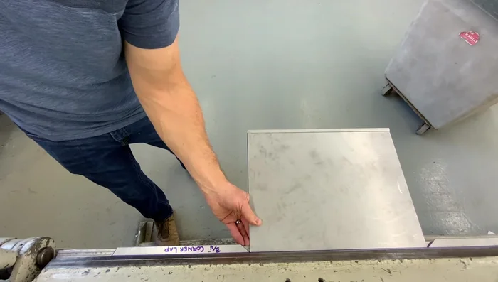 Bending the longer sides: Bend the two longer sides (with corner lap seams) up 90 degrees. Ensure the corner lap seam bends up at the same time as the side.