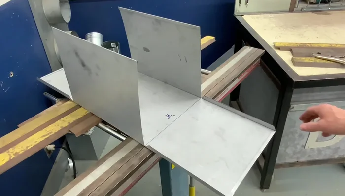 Bending the corner lap seams: Carefully bend the corner lap seams to the inside of the box.