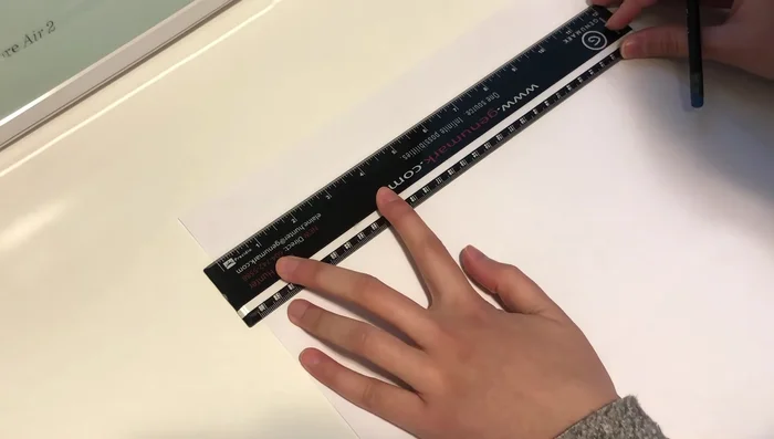 Cut strips of black cardstock and use double-sided tape to create a border around the white background.