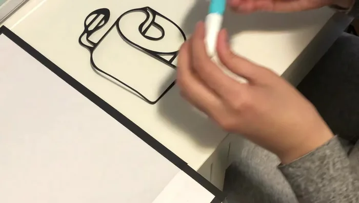 Glue the cut artwork onto the prepared background using liquid glue.