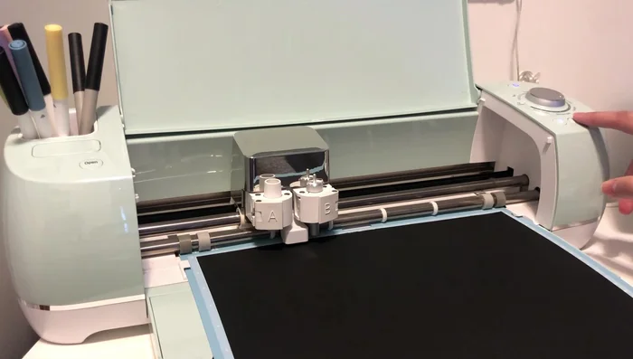 Load the cardstock into the Cricut machine and let it cut the design. This will cut out the toilet paper icon and text.