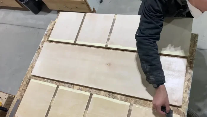 Apply glue to cabinet sides and shelf joints, ensuring full contact. Clamp firmly.