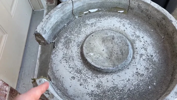 Mix a less watery, clay-like consistency quick-setting cement and pour it into the mold, ensuring it sits against the ground for stability.