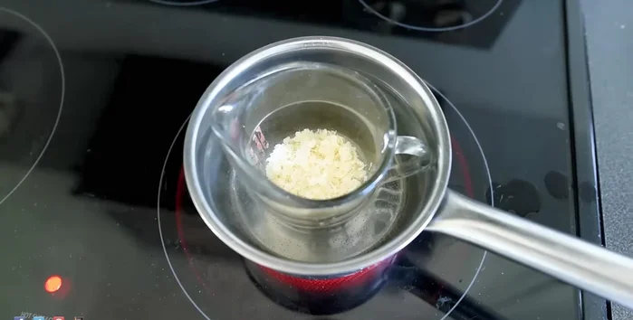 Melt the mixture in a double boiler until completely liquefied.