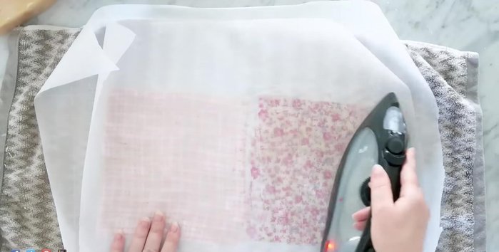 Cover with another sheet of parchment paper and iron on a cotton setting to ensure even distribution and seep to the other side.