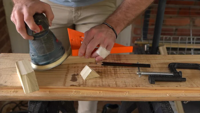 Sand down the edges and surfaces of both wood pieces to smooth out imperfections.