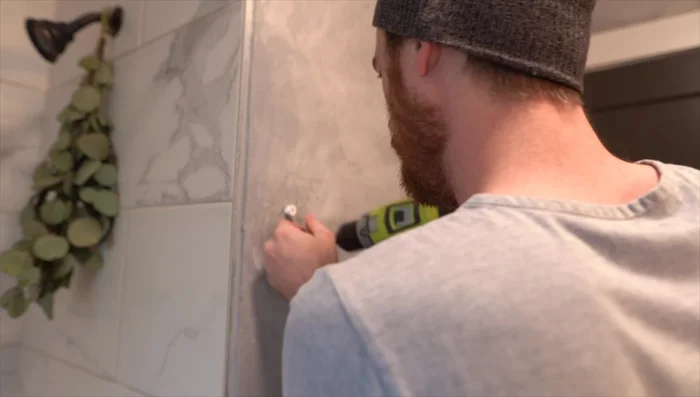 Attach the wood towel hook to the wall using the dowel screws.